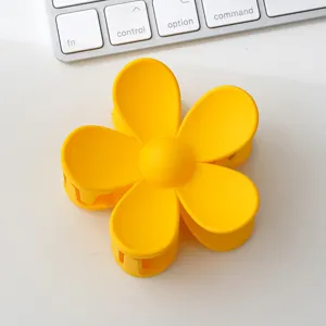 Cute yellow flower hair claw clip matte finish hair accessory for women daily styling main view