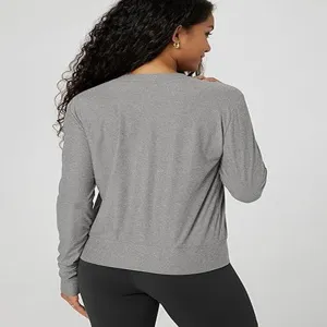 Solid grey crewneck long sleeve top detail view, casual slim fit activewear for women.