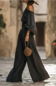 Detailed view of the stylish off-the-shoulder top and wide leg pants set in dark grey.