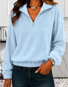 Detail view of the soft light blue fleece half-zip sweatshirt with cozy long sleeves.