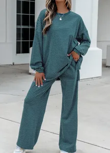 Detailed view of the dark green striped knit lounge set, featuring a relaxed long-sleeve top.