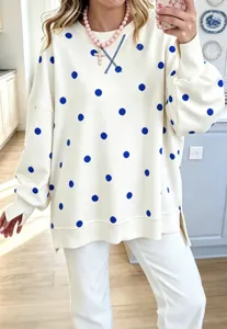 Close-up detail view of the casual loose polka dot sweatshirt with round collar and stitching.