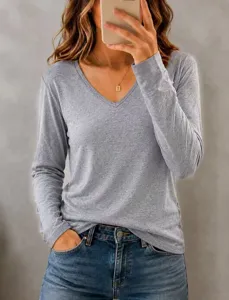 Casual solid v-neck long sleeve t-shirt for women, stylish basic top paired with blue jeans.