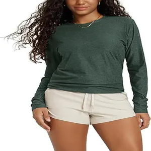 Close-up detail view of the solid green long sleeve crew neck top showcasing slim fit texture.