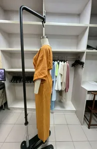 Orange off-shoulder top and wide-leg pants set, stylish two-piece outfit showing side view.