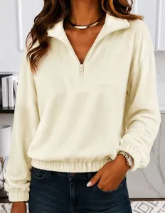 Close-up detail shot of women's half-zip fleece pullover showing lapel and cuff texture.