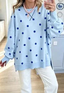 Blue sweatshirt detail, dark blue polka dots, crew neck, long sleeves with side slits.