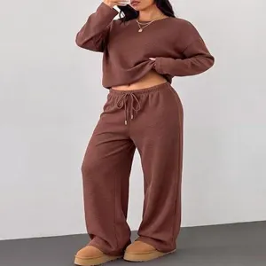 Brown waffle knit two piece lounge set, long sleeve crewneck top and wide leg pants detail.