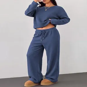 Detailed view of the casual long sleeve crewneck top and wide-leg trousers lounge set style.