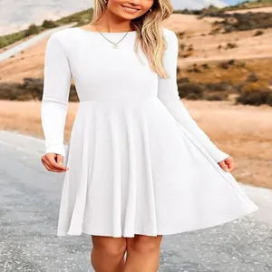 White long sleeve ribbed knit dress detail shot outdoors showing fabric texture and A-line swing.
