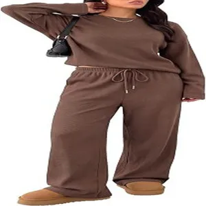Women casual solid color tracksuit set long sleeve crewneck top and wide leg pants.
