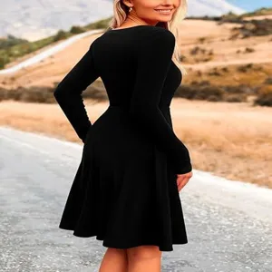 Black long-sleeve crewneck midi dress detail showing minimalist solid color fit and flare design.