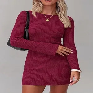 Detailed view of the burgundy ribbed knit dress, featuring long sleeves and fitted silhouette.