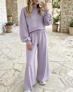 Purple polka dot lounge set featuring a cozy sweatshirt and high-waist wide-leg pants.
