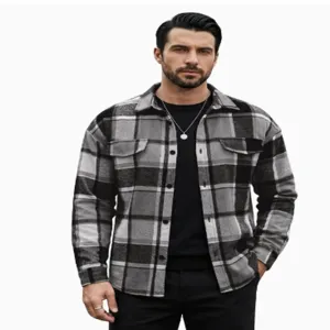 Detailed view of men's casual grey plaid lapel long sleeve shirt featuring dual chest pockets.
