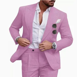 Pink linen suit detail showcasing the slim-fit jacket, crisp white shirt, and refined texture.