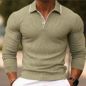 Detail view of men's long sleeve polo shirt, contrast collar piping and fine knit texture.