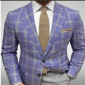 Detail shot of men's blue plaid suit blazer jacket paired with crisp white shirt and stylish tie.