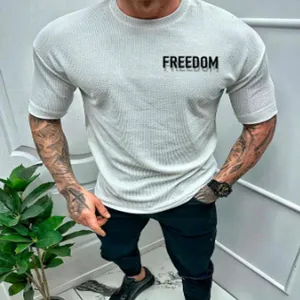 Close-up detail of light grey textured short sleeve men t-shirt with chest print.