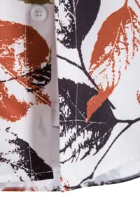 Close-up detail of men casual short sleeve shirt featuring abstract leaf digital print fabric.