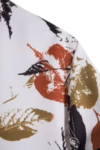 Close-up detail of men's casual short sleeve shirt fabric with colorful digital leaf print.