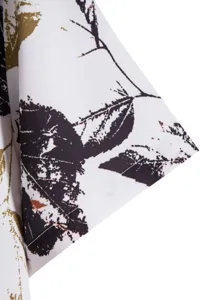 Close-up detail of men's casual short sleeve shirt showing cuff and abstract print fabric.