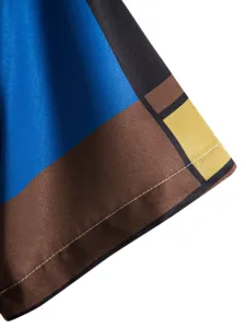 Close up detail of mens abstract geometric print short sleeve casual shirt sleeve fabric.