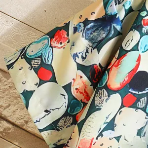 Men casual summer short sleeve abstract pebble print shirt fabric detail close up view.