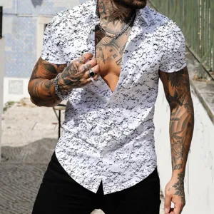 Detail view of men's short sleeve shirt with black ink splatter print on white background.