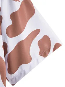 Men's casual shirt detail view featuring trendy brown cow print pattern and fine stitching.