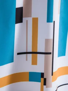 Close-up detail of mens summer casual short sleeve shirt featuring modern geometric print.