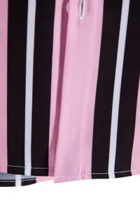 Detail view of men's striped shirt with pink, black, and white stripes and neat stitching.