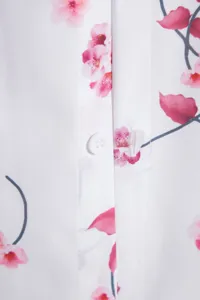 Close-up detail of mens casual shirt featuring vibrant pink cherry blossom digital print fabric.
