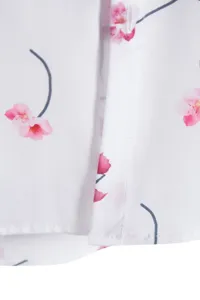 Close-up detail of men's casual short sleeve shirt featuring digital cherry blossom print.