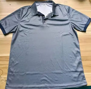 Close-up detail of the grey mens short sleeve polo shirt with dark blue contrast collar.