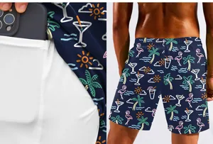 Men's summer beach shorts detail, digital tropical print with pocket lining design.