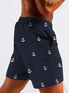 Men's navy blue beach board shorts with classic white anchor print for summer vacation.