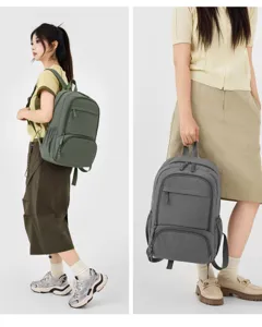 Detail view of the casual college style backpack showing multiple pockets and compartments.