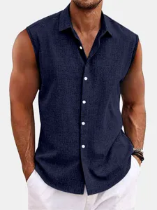 Close-up detail of the dark blue sleeveless shirt, showing textured fabric and neat lapel collar.