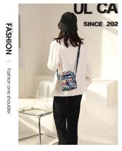 Colorful printed nylon crossbody bag detail, casual shoulder bag with zipper and adjustable strap.