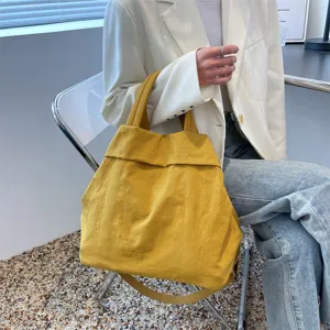Stylish yellow canvas tote bag for women, large capacity casual shoulder and crossbody bag.