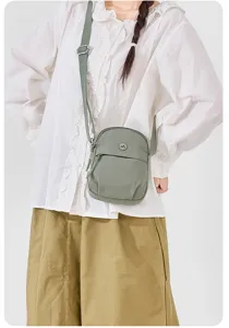 Green nylon crossbody bag for women, lightweight casual small shoulder bag with adjustable strap.