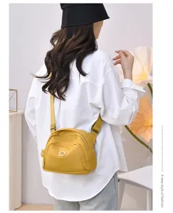 Detailed view of casual nylon shell crossbody bag for women, lightweight solid color shoulder design.