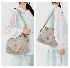 Detail view of the lightweight nylon shoulder bag showing multi-layer capacity and details.