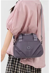 Detail view of a women's nylon casual shoulder and crossbody bag with multiple compartments.