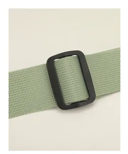 Close-up detail of the durable nylon shoulder strap and adjustable plastic buckle.