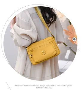 Yellow nylon crossbody bag, casual multi-pocket shoulder bag for women daily commute.