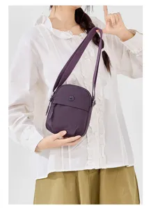 Casual purple nylon crossbody bag detail featuring lightweight design and adjustable shoulder strap.