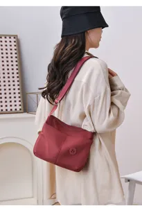 Casual nylon shoulder bag for women, stylish crossbody commuter bag with adjustable strap.