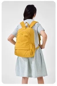 Casual yellow lightweight backpack for women, daily commuter school bookbag and travel daypack.